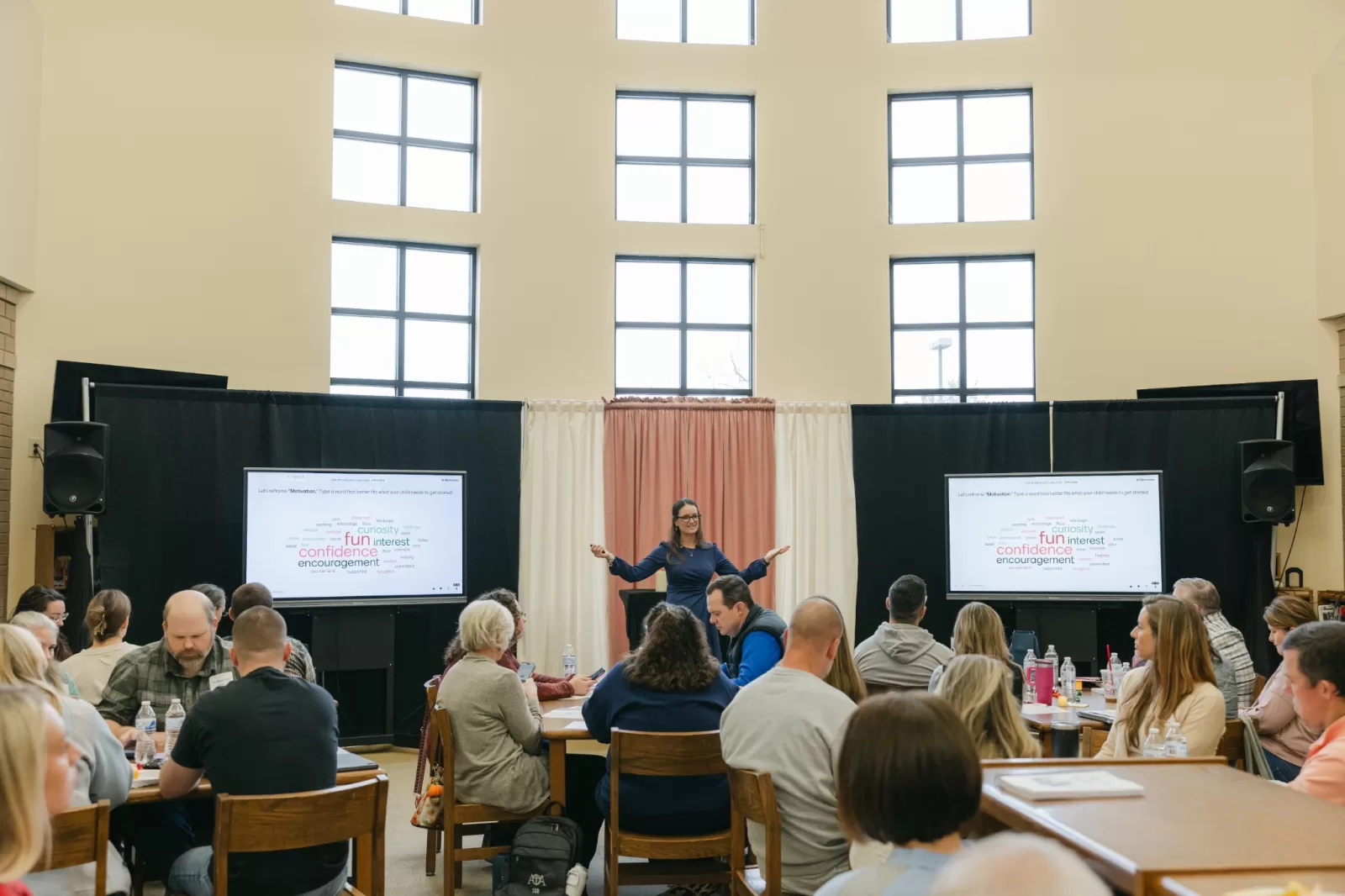 Cindy North presenting to a live audience during a keynote workshop